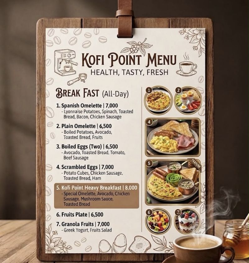 Kofi Point's new all-day breakfast menu on a wooden clipboard, next to a cup of coffee.